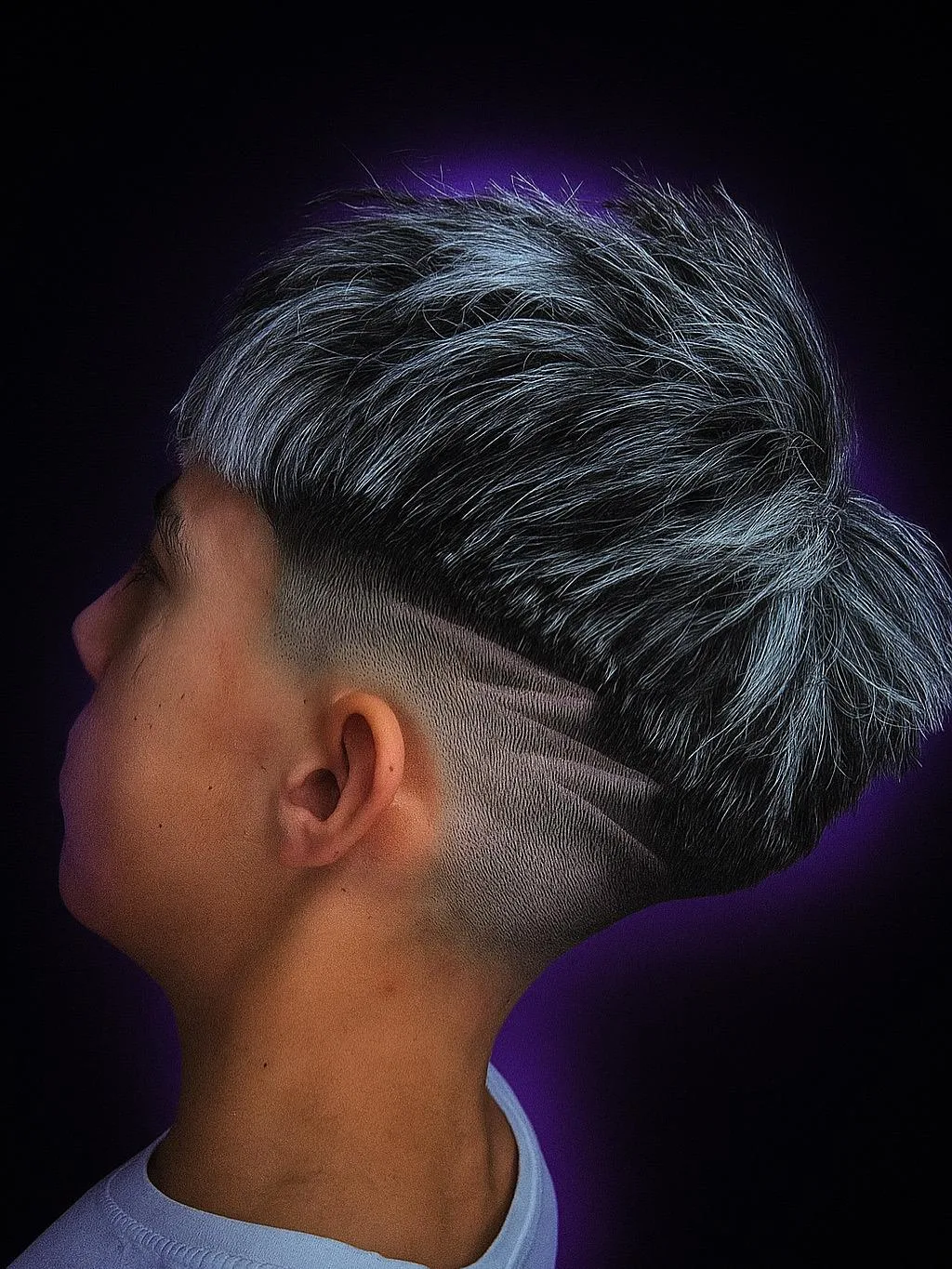 Degradado con diseño a navaja y mechas plateadas realizado en Tino New Barber